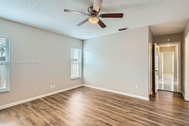 11035 NW 27th St, Sunrise, FL 33322 - spare room with a textured ceiling, wood finished floors, and a ceiling fan
