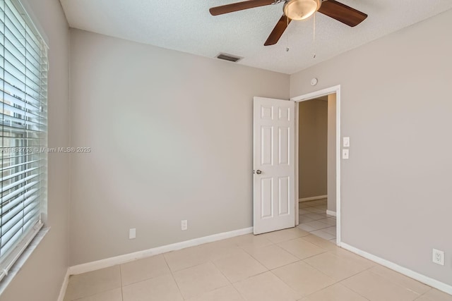 11035 NW 27th St, Sunrise, FL 33322 - empty room with ceiling fan, light tile patterned flooring, and a textured ceiling