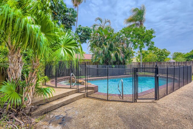 11035 NW 27th St, Sunrise, FL 33322 - view of pool featuring a fenced backyard, an in-ground hot tub, and a patio