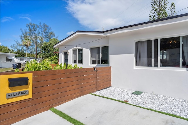 2380 NE 137th St, North Miami Beach, FL 33181 - view of property exterior with stucco siding and a patio area