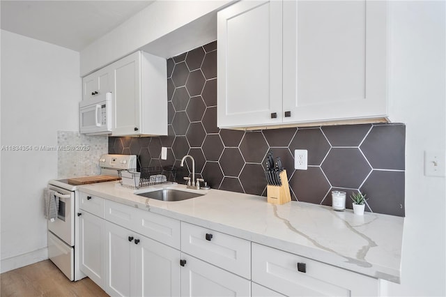 2380 NE 137th St, North Miami Beach, FL 33181 - kitchen with white appliances, backsplash, and white cabinetry