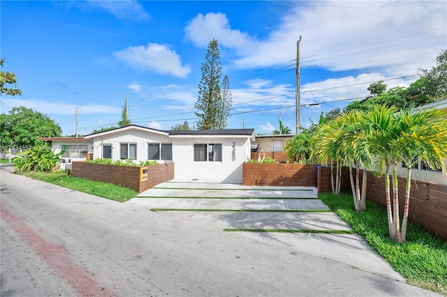 2380 NE 137th St, North Miami Beach, FL 33181 - single story home featuring stucco siding and a fenced front yard