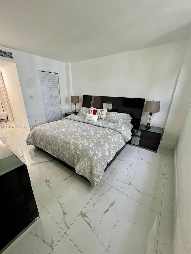 680 NE 64th St Unit A501, Miami, FL 33138 - bedroom featuring light marble finish floors and a closet