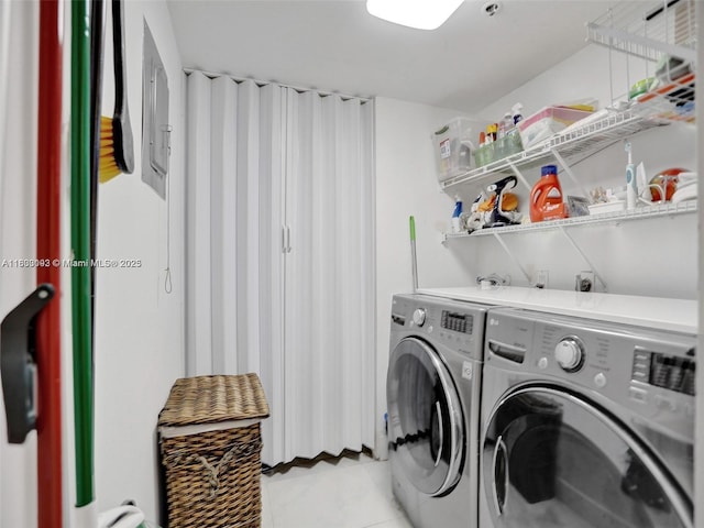 1627 Brickell Ave Unit 605, Miami, FL 33129 - laundry room with washing machine and clothes dryer and light tile patterned floors