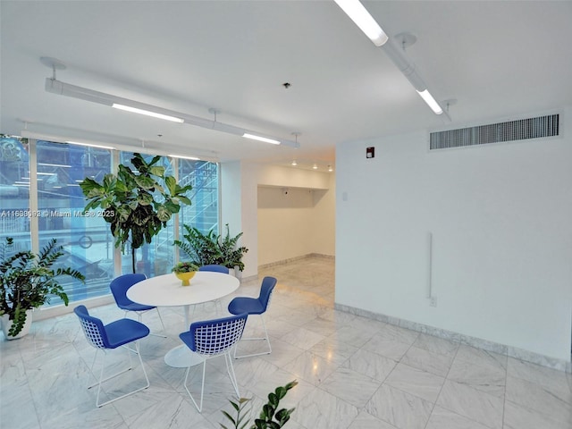 1627 Brickell Ave Unit 605, Miami, FL 33129 - unfurnished dining area with baseboards and light marble finish flooring