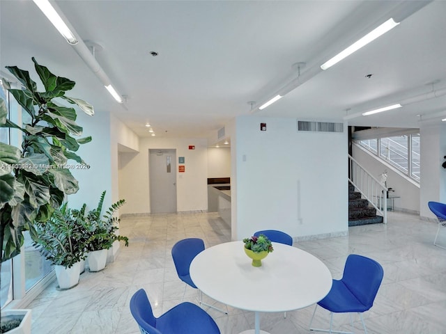 1627 Brickell Ave Unit 605, Miami, FL 33129 - dining area with stairway and light marble finish floors