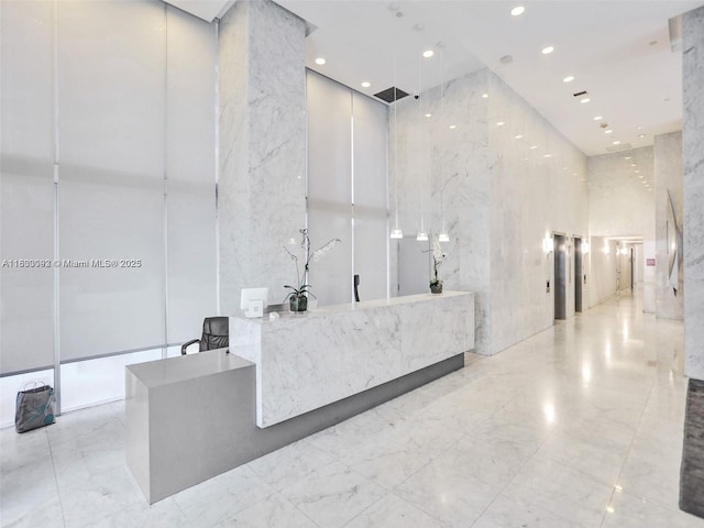 1627 Brickell Ave Unit 605, Miami, FL 33129 - reception with a high ceiling and recessed lighting