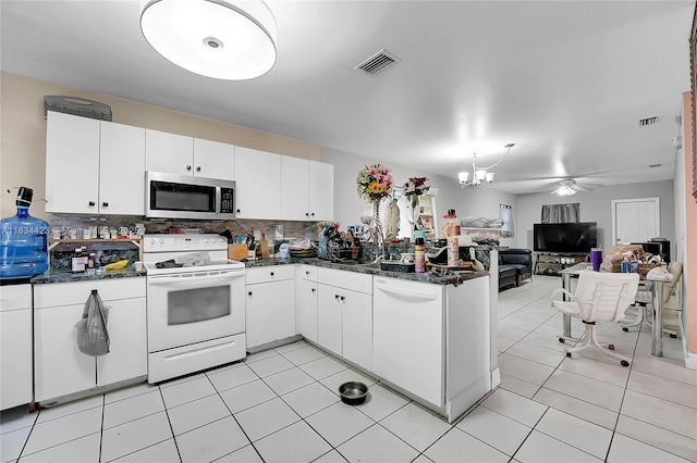 1303 W 6th St, Riviera Beach, FL 33404 - kitchen with white appliances, backsplash, open floor plan, a peninsula, and white cabinets