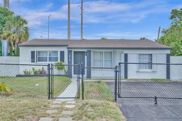 1610 S 29th Ave, Hollywood, FL 33020 - view of front of house with a gate, stucco siding, a fenced front yard, and a shingled roof