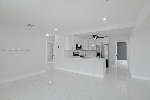 1610 S 29th Ave, Hollywood, FL 33020 - kitchen featuring appliances with stainless steel finishes, light marble finish flooring, white cabinetry, ceiling fan, and recessed lighting