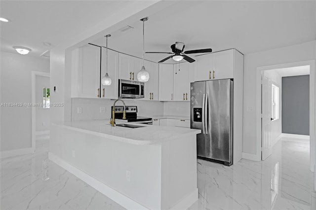 1610 S 29th Ave, Hollywood, FL 33020 - kitchen featuring appliances with stainless steel finishes, light marble finish floors, a peninsula, light countertops, and a ceiling fan