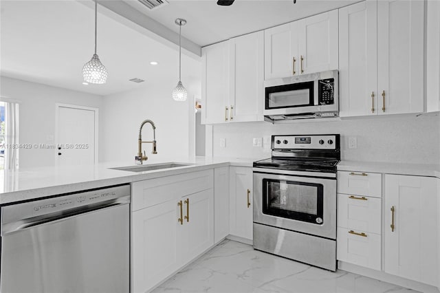 1610 S 29th Ave, Hollywood, FL 33020 - kitchen with appliances with stainless steel finishes, light countertops, light marble finish floors, white cabinets, and recessed lighting