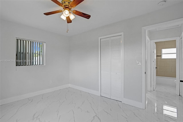 1610 S 29th Ave, Hollywood, FL 33020 - unfurnished bedroom featuring light marble finish flooring, a closet, and a ceiling fan
