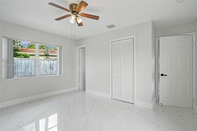 1610 S 29th Ave, Hollywood, FL 33020 - unfurnished bedroom with light marble finish flooring, a closet, and a ceiling fan