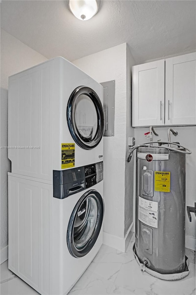 1610 S 29th Ave, Hollywood, FL 33020 - laundry room featuring water heater, stacked washer / dryer, cabinet space, and light marble finish floors