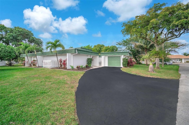 5820 Australian Pine Dr, Tamarac, FL 33319 - view of front of home with an attached garage, driveway, a front lawn, and stucco siding
