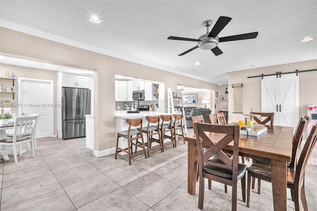5820 Australian Pine Dr, Tamarac, FL 33319 - dining space featuring a barn door, a ceiling fan, ornamental molding, recessed lighting, and a textured ceiling
