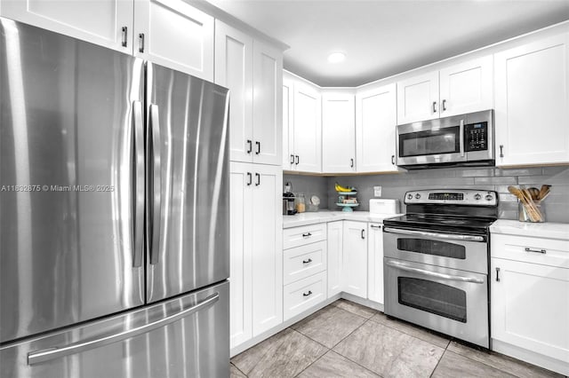 5820 Australian Pine Dr, Tamarac, FL 33319 - kitchen featuring appliances with stainless steel finishes, light countertops, tasteful backsplash, white cabinets, and recessed lighting