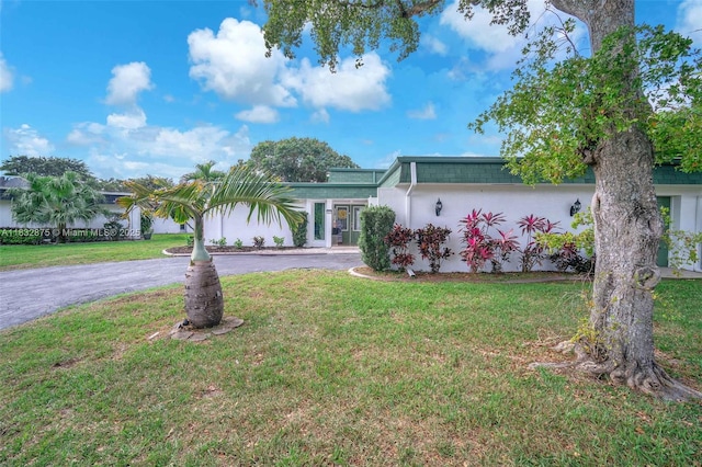 5820 Australian Pine Dr, Tamarac, FL 33319 - view of front of house featuring curved driveway, a front yard, and stucco siding