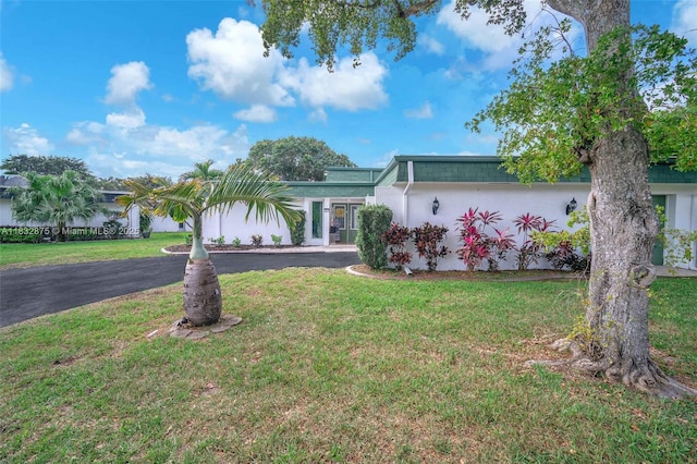 5820 Australian Pine Dr, Tamarac, FL 33319 - view of front facade featuring a front yard and stucco siding