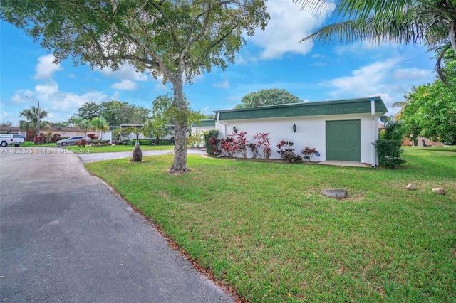 5820 Australian Pine Dr, Tamarac, FL 33319 - view of front of property with a front yard and stucco siding