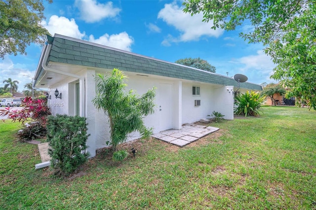 5820 Australian Pine Dr, Tamarac, FL 33319 - rear view of property featuring mansard roof, stucco siding, a yard, and a shingled roof
