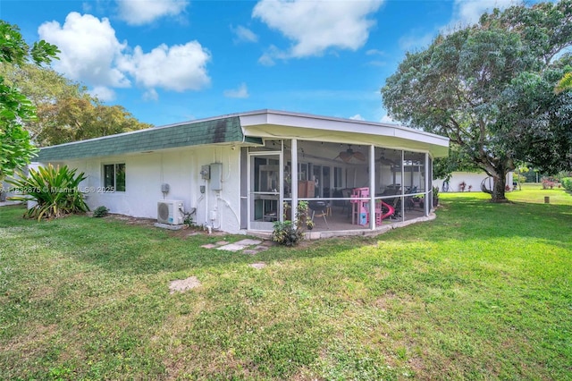 5820 Australian Pine Dr, Tamarac, FL 33319 - rear view of house with a sunroom, a lawn, ceiling fan, stucco siding, and a shingled roof