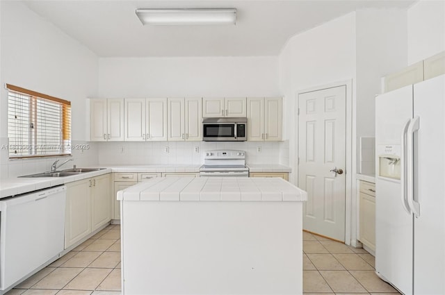 2456 SE 19th Ct, Homestead, FL 33035 - kitchen with white appliances, tile counters, a kitchen island, and light tile patterned floors
