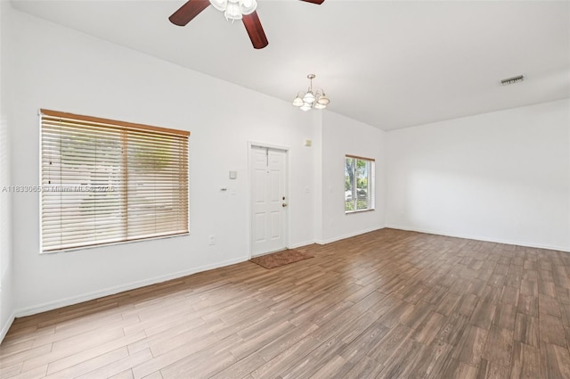 2456 SE 19th Ct, Homestead, FL 33035 - empty room featuring a ceiling fan, wood finished floors, and a chandelier