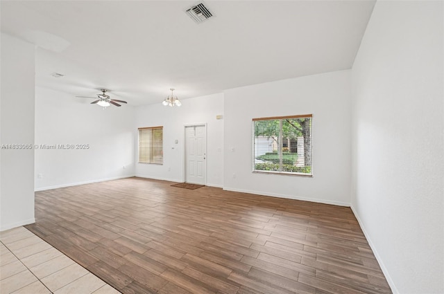 2456 SE 19th Ct, Homestead, FL 33035 - unfurnished living room with wood finished floors, a chandelier, and a ceiling fan