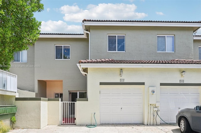 2456 SE 19th Ct, Homestead, FL 33035 - back of house with stucco siding, an attached garage, and a tiled roof