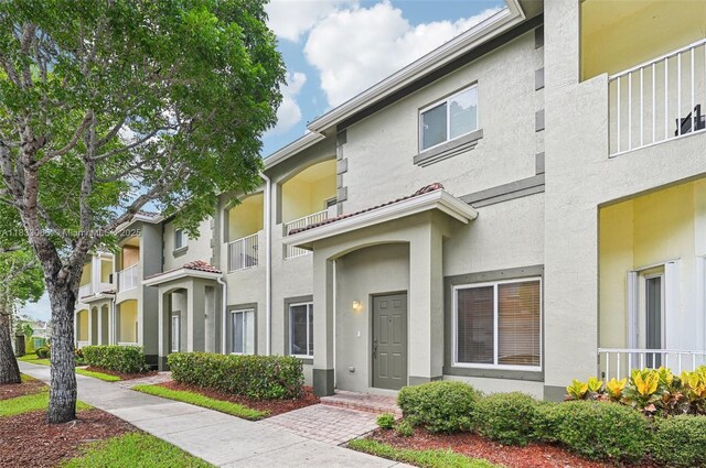 2456 SE 19th Ct, Homestead, FL 33035 - view of front of property featuring stucco siding and a balcony