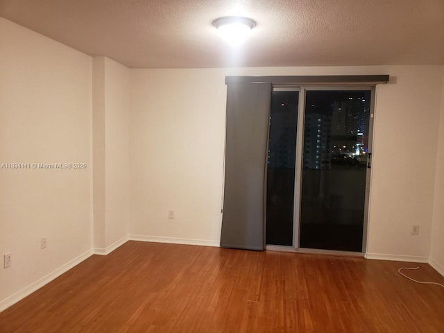 36 NW 6th Ave Unit 906, Miami, FL 33128 - spare room featuring wood finished floors and a textured ceiling
