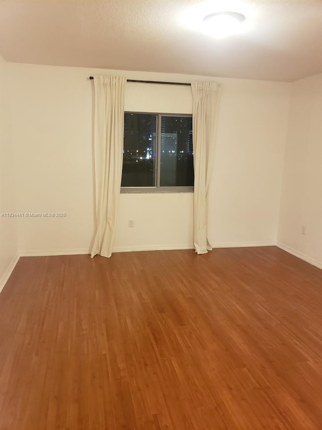 36 NW 6th Ave Unit 906, Miami, FL 33128 - empty room with wood finished floors and baseboards