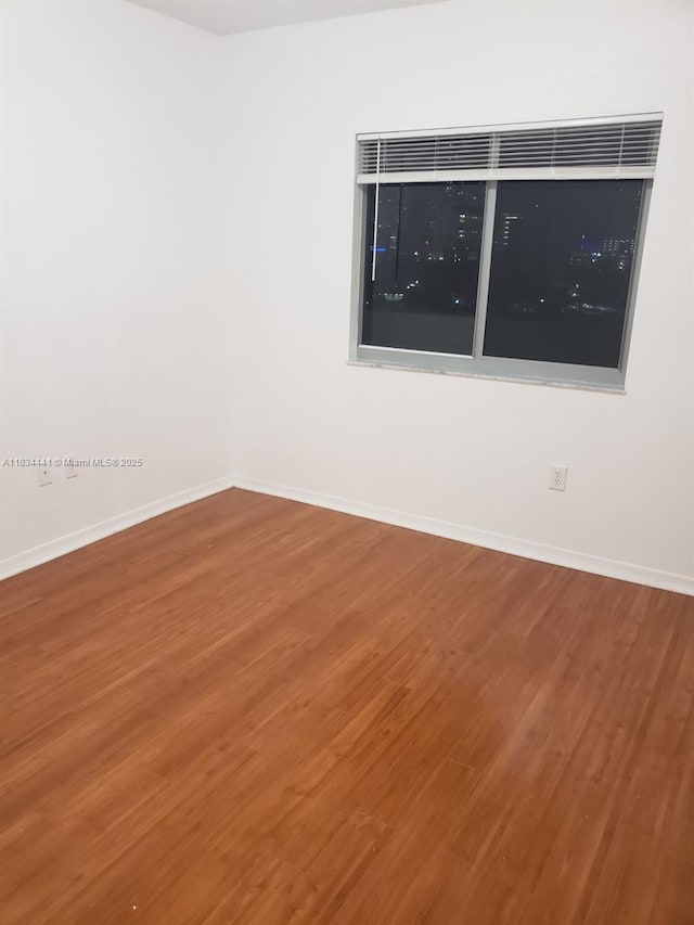 36 NW 6th Ave Unit 906, Miami, FL 33128 - unfurnished room featuring wood finished floors and baseboards