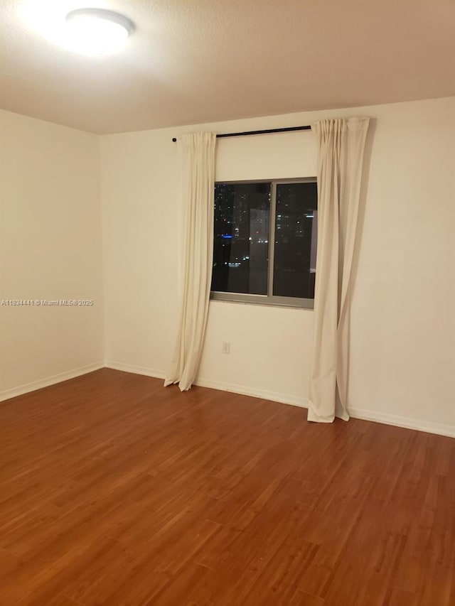 36 NW 6th Ave Unit 906, Miami, FL 33128 - unfurnished room with wood finished floors and baseboards