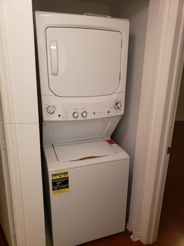 36 NW 6th Ave Unit 906, Miami, FL 33128 - washroom with stacked washer / dryer and dark wood-type flooring