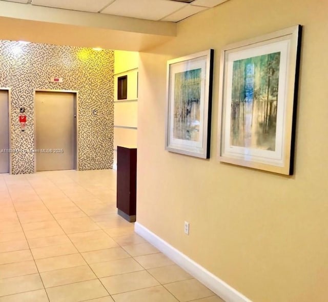 36 NW 6th Ave Unit 906, Miami, FL 33128 - corridor featuring light tile patterned floors, elevator, and a drop ceiling