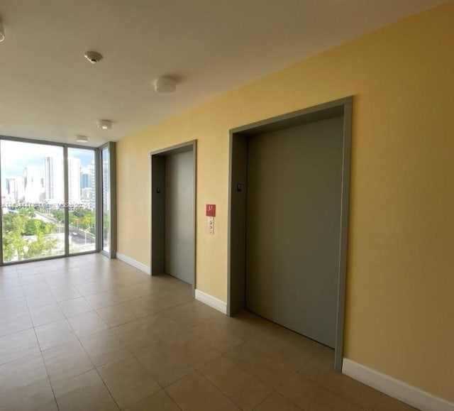 36 NW 6th Ave Unit 906, Miami, FL 33128 - spare room featuring elevator, floor to ceiling windows, and tile patterned flooring