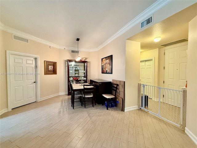 3001 NE 185th St Unit 112, Aventura, FL 33180 - dining space with light wood-style flooring and ornamental molding
