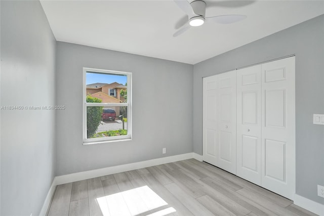 2349 NW 34th Ave, Coconut Creek, FL 33066 - unfurnished bedroom with wood finished floors, a closet, and a ceiling fan