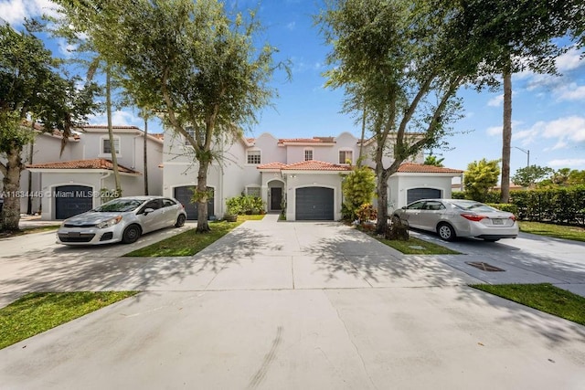 985 SW 147th Ct, Miami, FL 33194 - mediterranean / spanish-style house with concrete driveway, stucco siding, a tiled roof, and an attached garage