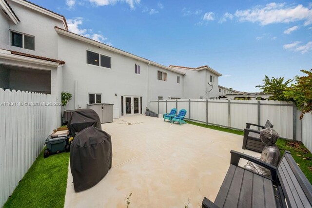 985 SW 147th Ct, Miami, FL 33194 - rear view of house with french doors, a fenced backyard, stucco siding, and a patio area
