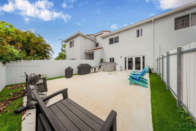 985 SW 147th Ct, Miami, FL 33194 - fenced backyard with french doors, a patio, and area for grilling