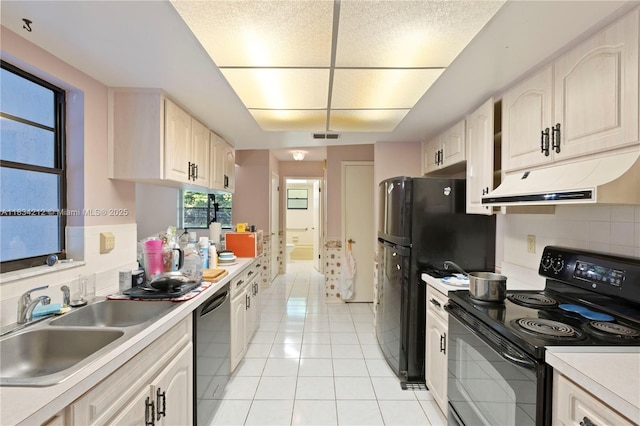 12738 Split Oak Dr, Hudson, FL 34667 - kitchen featuring black appliances, under cabinet range hood, light countertops, decorative backsplash, and light tile patterned flooring