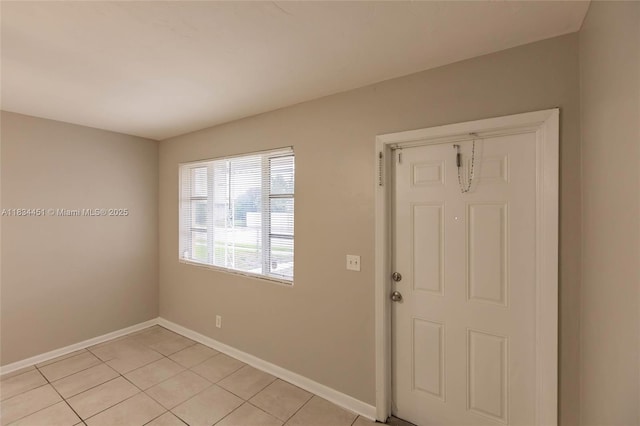 4423 Lake Ave, West Palm Beach, FL 33405 - entryway with baseboards and light tile patterned floors