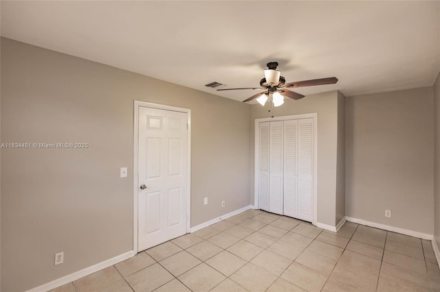 4423 Lake Ave, West Palm Beach, FL 33405 - unfurnished bedroom with a closet, light tile patterned flooring, and ceiling fan