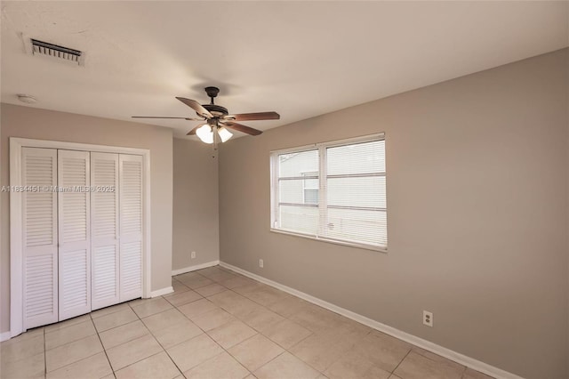 4423 Lake Ave, West Palm Beach, FL 33405 - unfurnished bedroom with a closet, light tile patterned floors, and ceiling fan