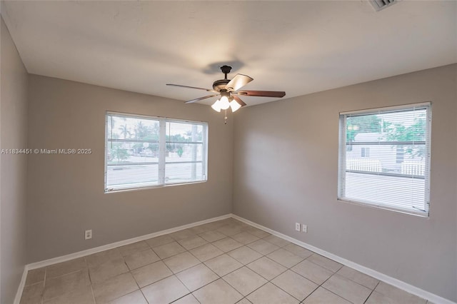 4423 Lake Ave, West Palm Beach, FL 33405 - spare room featuring a ceiling fan, healthy amount of natural light, and light tile patterned floors