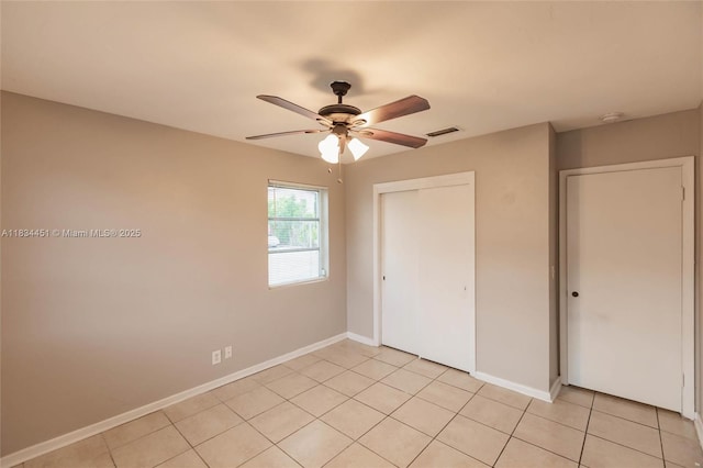 4423 Lake Ave, West Palm Beach, FL 33405 - unfurnished bedroom featuring a closet, light tile patterned floors, and ceiling fan